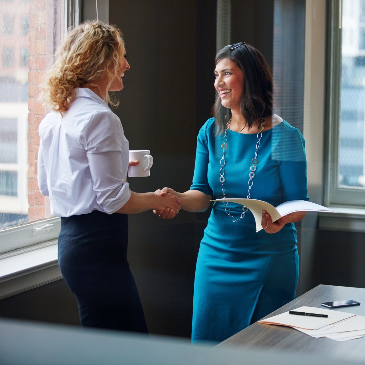 Two businesswomen in an office representing Laura and Kate
