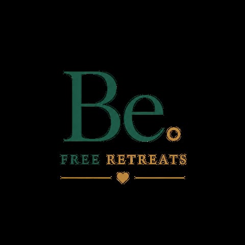 Be. Free Retreats logo featuring green and gold text with decorative heart symbol